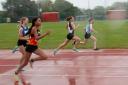 Swindon Harriers' Freya McMeeking (second from right) takes part in in the Regional Final of the UK Youth Development League at the County Ground during torrential rain