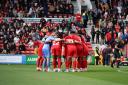 Swindon Town players in a huddle before the 6-0 victory over Crawley Town