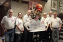 Speedway fans present cheque to charity