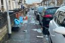Rubbish strewn all over a street in central Swindon after Storm Isha