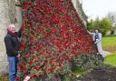 Geoff Jackson -Haines and Lynn Thrussell with a Poppy display at St Michael's Church in Lyneham