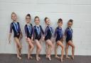 Swindon School of Gymnastics' A League squad collect their bronze medals at the West Country League Championships