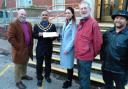Mayor Abdul Amin receives the petition from Stanka Adamcova and Tony Mayer (red jacket) and others