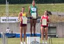 Swindon Harriers' Laila-Jae Belgrave stands on top of the podium after her win at the South West Schools Track and Field Championships at the Exeter Arena
