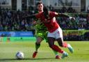 Forest Green Rovers defender Jordan Moore-Taylor wrestles with Swindon Town loanee Tyreece Simpson