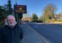Cllr Jim Grant next to a new digital sign on Kingshill Road