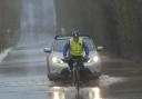 One brave cyclist braves the floods over the causeway at Staverton to get to work.