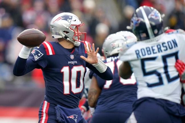 New England Patriots quarterback Mac Jones (10) passes under pressure