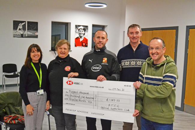 Swindon Town Official Supporters Club members Chris Kyle, Pete Norris, and Tim Keen hand over a cheque to Prospect Hospice alongside Jon Holloway of Swindon Town Community Foundation Photo: OSC