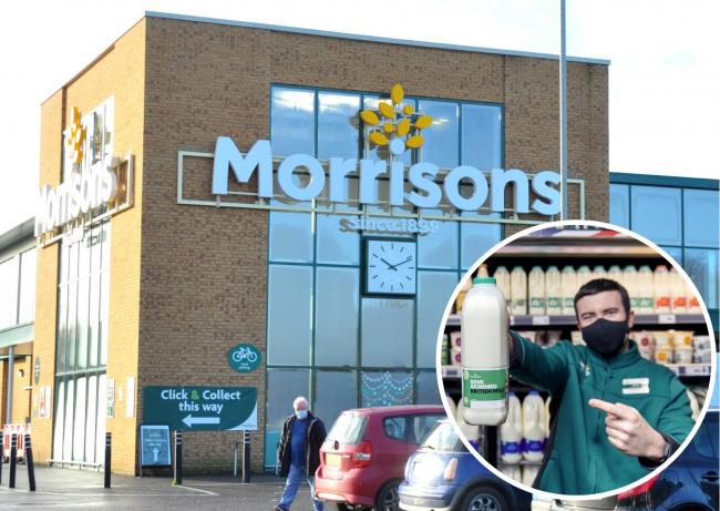 Morrisons at Dorcan and a member of staff holding a bottle of own-brand milk