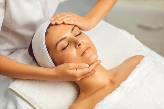 A woman having a face massage. Credit: Canva