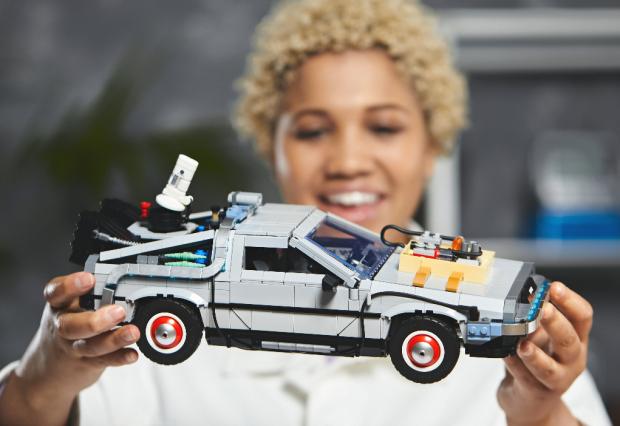 Swindon Advertiser: A woman holding the LEGO Back to The Future Delorean set. Credit: LEGO