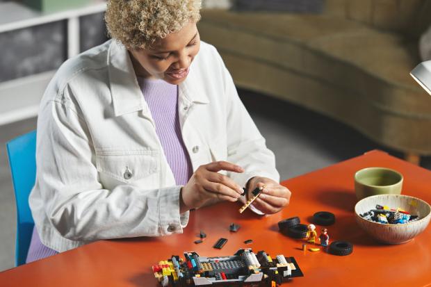 Swindon Advertiser: A woman putting together the LEGO Delorean. Credit: LEGO