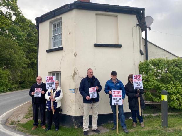 Swindon Advertiser: Protestors stand outside the Former Toll House to show the damage