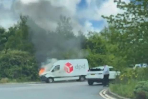 Fire engines respond to van up in flames at shopping centre