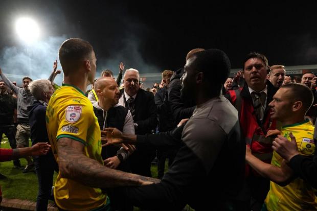 Swindon players surrounded by opposition fans after play-off defeat. Photo: PA
