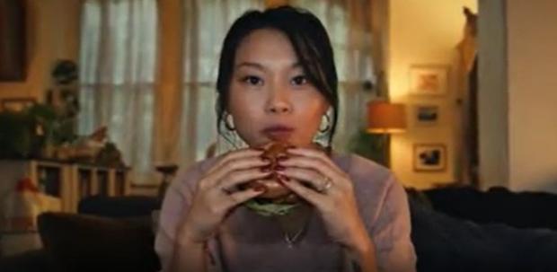 Swindon Advertiser: A shot from the now banned Tesco advert of a woman eating a burger (Tesco/PA)