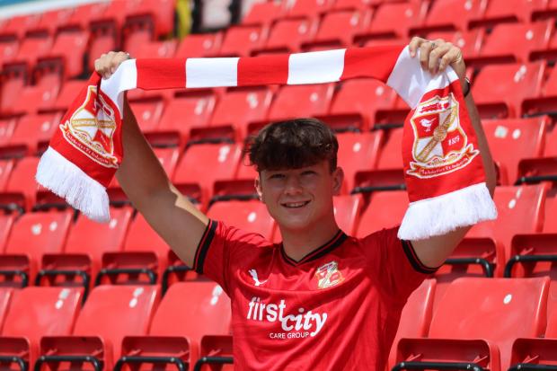 New Swindon Town signing Oscar Massey holds up a scarf at his County-Ground unveiling on Wednesday Photo: Rob Grady