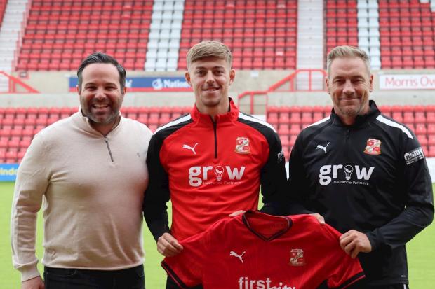 Former Manchester United left-back Reece Devine with technical director Sandro Di Michele and head coach Scott Lindsey Photo: Rob Grady