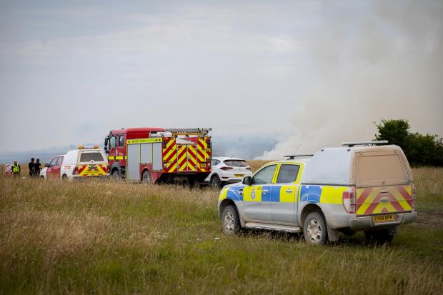 Swindon Advertiser: Soldiers pulled from a training exercise to help battle Salisbury Plain wildfires. Picture: SWNS