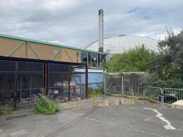 Swindon Advertiser: A bin compound full of rubbish and a bike rack full of plants