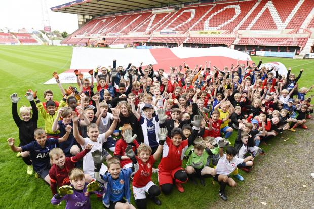 Swindon Advertiser: Swindon Town's Summer Camp show their support for England's Lionesses with Nationwide's huge flag. Pictures: DAVE COX