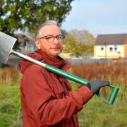 Volunteer Matthew French runs the community garden