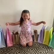 Six-year-old Thea Brunton with the goody bags she made to help make children happy Photo: Hayley Brunton
