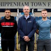 New Chippenham Town signings Alefe Santos (left) and Daniel Griffiths (right) either side of chairman Neil Blackmore