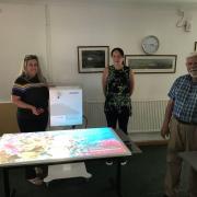 Coun Richard Hailstone, coun Rebecca Ross with Joanne Newman test drive the sensory table Photo: Haydon Wick Parish Council