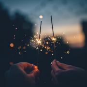 Two people holding sparklers for Bonfire night. Credit: Canva