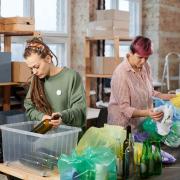 Two women sorting out the recycling. Credit: Canva