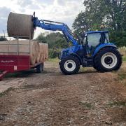 Kevin loading hay bales onto a trailer