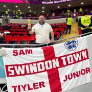 Three lions on a shirt: Sam and his Swindon-themed England flag have been lighting up Qatar.