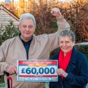 Bill Puffett and his wife Linda pose with the £60,000 cheque.