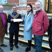 Mayor Abdul Amin receives the petition from Stanka Adamcova and Tony Mayer (red jacket) and others