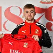 Swindon Town’s new signing Jake Cain poses for the camera after penning a two-and-a-half-year contract   Pic: Callum Knowles