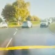 Police chase BMW in rush hour traffic going wrong way on roundabout