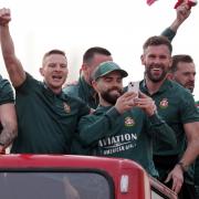 Wrexham’s Paul Mullin (left), Wrexham’s Elliot Lee (centre) and Wrexham’s Ben Foster seen on the open top bus during a victory parade in Wrexham