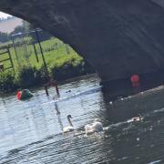 Divers helping to retrieve parts of the wall of Lechlade's Halfpenny Bridge as repair work is set to get underway