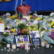 Lit candles among the flowers and messages left in tribute to Nottingham Panthers' ice hockey