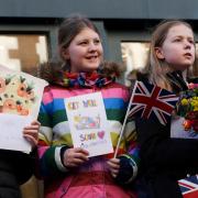 School children from Swindon presented the Queen with 'get well soon' cards for Charles.