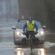 One brave cyclist braves the floods over the causeway at Staverton to get to work.