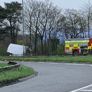 One fire engine remained with the crashed van after the fire was extinguished.