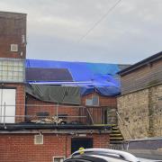 The damaged section of the Tree Nightclub building covered up with tarpaulin after a fire