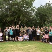 Children and teachers celebrate the refurbishment of the memorial garden