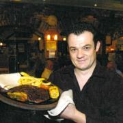 Spotted Cow manager Tony Kear-Smith poses for a food review photo in April 2006.
