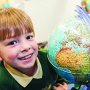 Barnaby exploring the globe at Longleaze Primary School