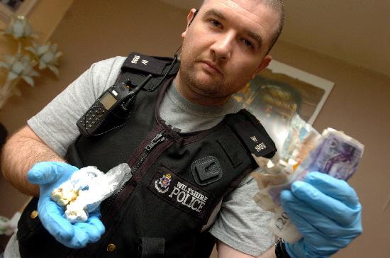 PC Billy O'Sullivan with what is believed to be drugs found at the flat