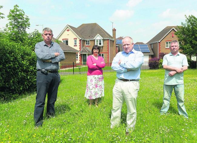 Upset residents are complaining about Thames Water’s plans to build two sewage pumps on Queen Elizabeth Drive. Pictured are Andrew Hargreaves, Linda Hayes, Brian McLean and Roland Hayes                 Picture: THOMAS KELSEY